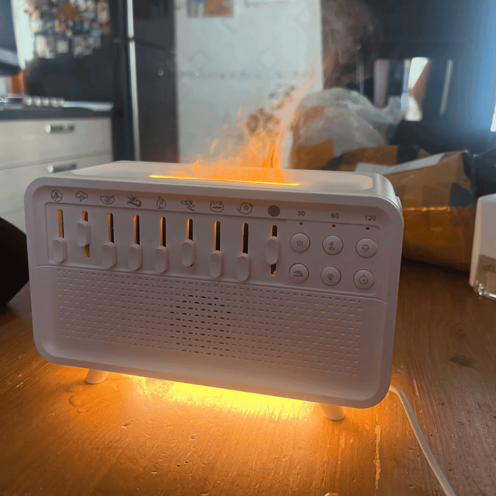 White electronic device with glowing orange light on a wooden surface
