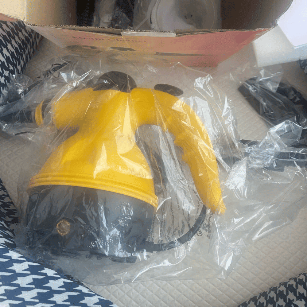Yellow and black tool in clear plastic packaging on a patterned surface