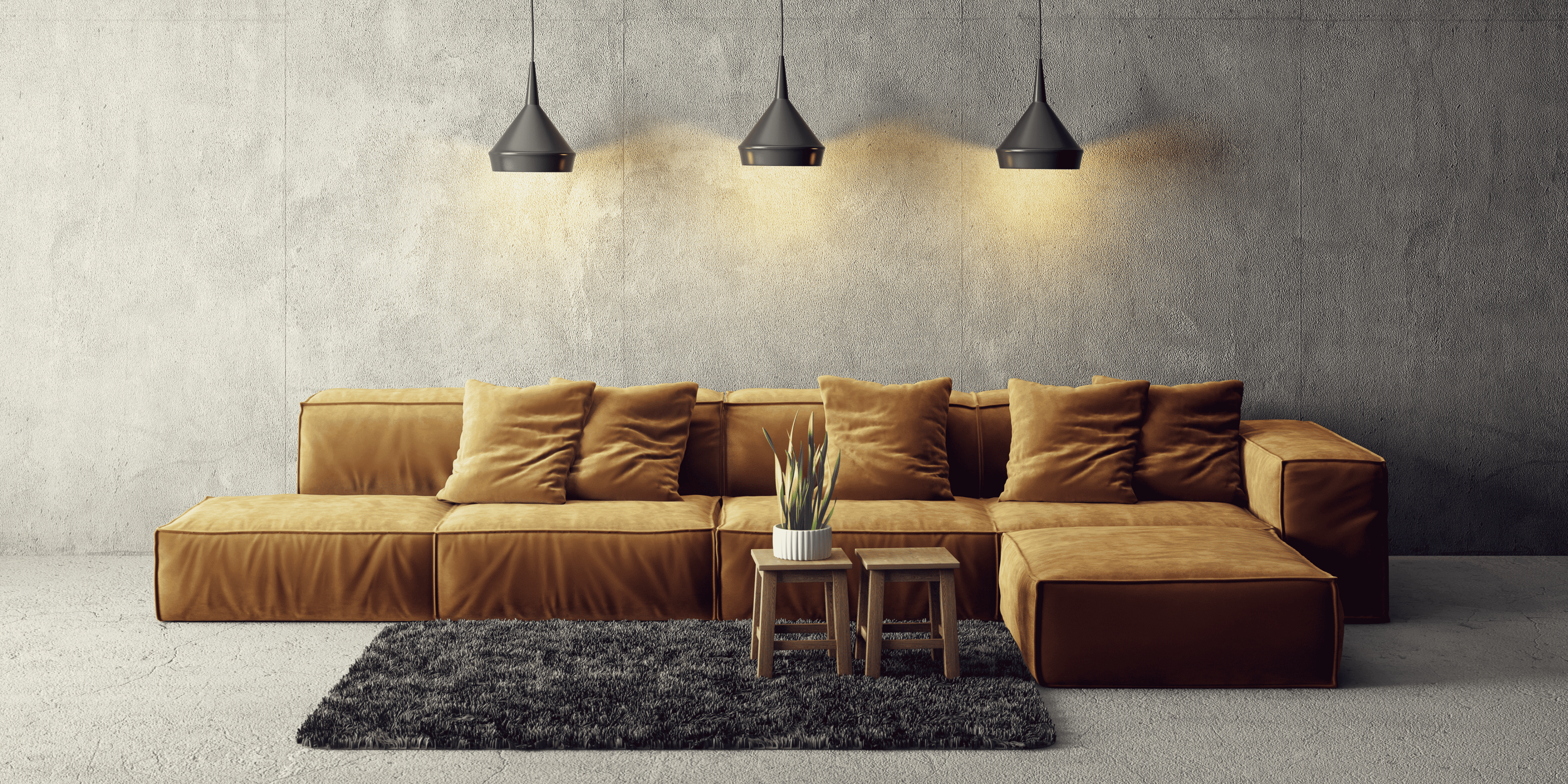 Brown sectional sofa in a modern living room with concrete walls and pendant lights.